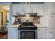 Well-equipped kitchen with white cabinetry, stainless steel appliances, and neutral countertops at 113 Hidden Ln, Mooresville, NC 28117