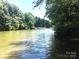 Expansive lake view showcasing calm waters and distant waterfront properties, perfect for peaceful living and recreation at 113 Hidden Ln, Mooresville, NC 28117