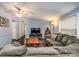 Bright living room featuring a large gray couch, a mounted TV, and neutral decor at 113 Hidden Ln, Mooresville, NC 28117