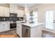 Contemporary kitchen featuring sleek stainless steel appliances and a center island with a sink at 1234 Wendall Ln, Mount Pleasant, NC 28025