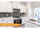 Well-lit kitchen boasts white cabinetry, stainless steel appliances, sleek countertops, and stylish backsplash at 1234 Wendall Ln, Mount Pleasant, NC 28025