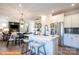 Modern kitchen features white cabinets, stainless steel appliances, an island with bar seating, and open dining area at 1234 Wendall Ln, Mount Pleasant, NC 28025