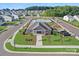 Aerial view of the community clubhouse, pool, playground, parking lot, and surrounding homes at 127 Wheeler Trl, Statesville, NC 28625