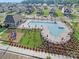 Aerial view of the community pool, clubhouse, and playground among residential homes at 127 Wheeler Trl, Statesville, NC 28625