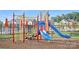 Bright, colorful playground features slides, climbing structures and a wood chip ground covering in a community setting at 127 Wheeler Trl, Statesville, NC 28625