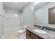 Bathroom features a granite countertop sink, tiled floors, and a tub with shower at 12706 Ballyliffin Dr, Pineville, NC 28134