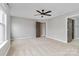 Carpeted bedroom boasts a ceiling fan, neutral paint, and a spacious interior at 12706 Ballyliffin Dr, Pineville, NC 28134