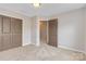 Neutral bedroom featuring double closet doors and plush carpeting at 12706 Ballyliffin Dr, Pineville, NC 28134
