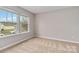 Bedroom featuring natural light, carpeted floors, and a view of the neighborhood at 12706 Ballyliffin Dr, Pineville, NC 28134