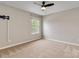 Empty bedroom with neutral carpet, ceiling fan, and window at 12706 Ballyliffin Dr, Pineville, NC 28134