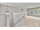 Upstairs bonus room with neutral paint, carpet, and many windows at 12706 Ballyliffin Dr, Pineville, NC 28134