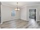 Elegant dining room boasting a modern chandelier and abundant natural light at 12706 Ballyliffin Dr, Pineville, NC 28134