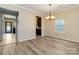 Inviting dining area with wood floors and a chandelier, adjacent to the kitchen at 12706 Ballyliffin Dr, Pineville, NC 28134