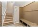 Welcoming entryway with stairs, storage bench and convenient coat hooks at 12706 Ballyliffin Dr, Pineville, NC 28134