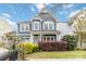 A quaint two-story home with light blue siding, lovely landscaping, and a cozy front porch at 12706 Ballyliffin Dr, Pineville, NC 28134