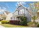 A charming two-story home with light blue siding, a cozy front porch, and colorful landscaping at 12706 Ballyliffin Dr, Pineville, NC 28134