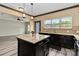 Stylish kitchen with granite countertops, island, stainless appliances, and natural light at 12706 Ballyliffin Dr, Pineville, NC 28134