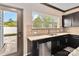 Well-lit kitchen features granite countertops, stainless steel appliances and backyard view at 12706 Ballyliffin Dr, Pineville, NC 28134
