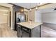 Eat-in kitchen features a large island, stainless steel refrigerator, and stylish pendant lights at 12706 Ballyliffin Dr, Pineville, NC 28134