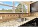A close up on the kitchen sink with large window and granite countertops at 12706 Ballyliffin Dr, Pineville, NC 28134