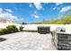 Backyard featuring a stone patio with a hot tub and stone grill at 12706 Ballyliffin Dr, Pineville, NC 28134