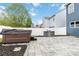 Backyard patio featuring a hot tub, stone grill, and privacy fence at 12706 Ballyliffin Dr, Pineville, NC 28134