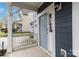 A cozy front porch with light blue siding, white trim, and a view of the neighborhood at 12706 Ballyliffin Dr, Pineville, NC 28134