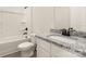 Bathroom featuring granite countertops, a tub and shower, and white cabinets at 129 Jacobs Hill Pl, Troutman, NC 28166