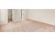 Large bedroom features neutral walls and carpet, with a doorway to the ensuite bathroom at 129 Jacobs Hill Pl, Troutman, NC 28166