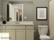 Bathroom with a white vanity, modern mirror, neutral wall paint, and decorative touches at 135 Wheeler Trl, Statesville, NC 28625