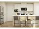 Bright kitchen featuring white cabinetry, stainless steel appliances, and a center island with seating at 135 Wheeler Trl, Statesville, NC 28625