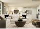 Spacious living room with a comfortable sofa, modern decor, and an open layout connecting to the kitchen at 135 Wheeler Trl, Statesville, NC 28625