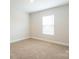 Empty bedroom with carpeted floors and a window for natural light at 142 Jacobs Hill Pl, Troutman, NC 28166