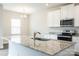 Open kitchen design featuring an island with a sink, granite countertops, and stainless steel appliances at 142 Jacobs Hill Pl, Troutman, NC 28166