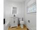 Bathroom featuring a vanity, toilet, modern fixtures, and natural light from the window at 1545 7Th Avenue Sw Dr, Hickory, NC 28602