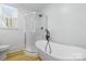 Bathroom featuring a stand alone tub, walk-in shower, modern fixtures, and natural light from the window at 1545 7Th Avenue Sw Dr, Hickory, NC 28602
