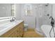 Modern bathroom with vanity, shower, and toilet, featuring warm-toned floors and plenty of natural light at 1545 7Th Avenue Sw Dr, Hickory, NC 28602