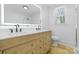 Bright bathroom featuring double vanity with modern fixtures, complemented by natural light from the window at 1545 7Th Avenue Sw Dr, Hickory, NC 28602