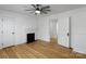 Bedroom with a fireplace, and three doors with wooden floors and white walls at 1545 7Th Avenue Sw Dr, Hickory, NC 28602