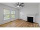 Bedroom with a fireplace, two windows, a ceiling fan, and wooden floors at 1545 7Th Avenue Sw Dr, Hickory, NC 28602