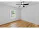 Bedroom with a window, ceiling fan, wooden floors, and white shiplap walls at 1545 7Th Avenue Sw Dr, Hickory, NC 28602