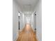 Hallway with wooden floors and white shiplap walls leading to a white front door at 1545 7Th Avenue Sw Dr, Hickory, NC 28602