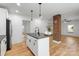 Bright, open kitchen features an island, shiplap walls, and a brick support post at 1545 7Th Avenue Sw Dr, Hickory, NC 28602