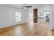 Spacious room featuring hardwood floors, large windows, and exposed brick pillar next to modern kitchen at 1545 7Th Avenue Sw Dr, Hickory, NC 28602