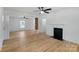Bright living room showcasing hardwood floors, white walls, fireplace, and open doorway with exposed brick pillar at 1545 7Th Avenue Sw Dr, Hickory, NC 28602