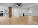 Open-concept layout with hardwood floors, fireplace, and exposed brick pillar connecting living room to kitchen at 1545 7Th Avenue Sw Dr, Hickory, NC 28602