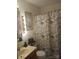 The bathroom is decorated with an Eiffel Tower themed shower curtain and vintage-style vanity lighting at 160 17Th Street Nw Pl # 3E, Hickory, NC 28601