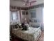 Comfortable bedroom featuring a decorative bedspread, pink ceiling fan, and wallpaper border at 160 17Th Street Nw Pl # 3E, Hickory, NC 28601