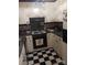 Cozy kitchen featuring checkered floors, white cabinets, and essential appliances at 160 17Th Street Nw Pl # 3E, Hickory, NC 28601