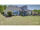 A backyard with a patio and grass areas, featuring an outdoor entertainment setup at 16524 Palisades Commons Dr, Charlotte, NC 28278